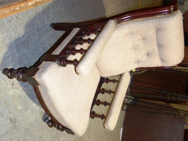 A Victorian mahogany framed scroll back upholstered armchair.   B5