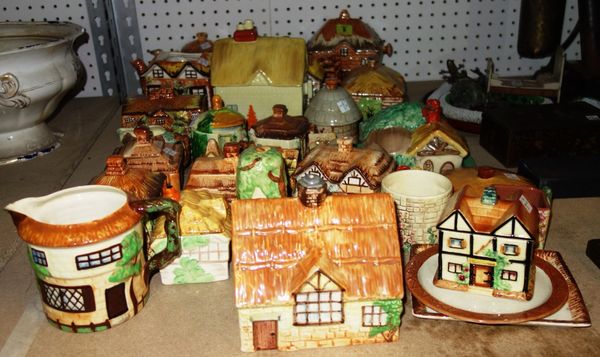 A quantity of ceramic cottages and similar tea pots and sugar bowls including Beswick and others.  S1M