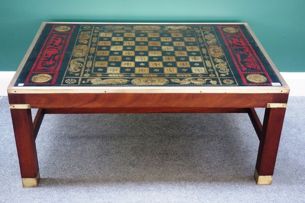 A 20th century brass bound campaign style coffee table, the top decorated with a chessboard and medieval scenes, 105cm wide.  K4