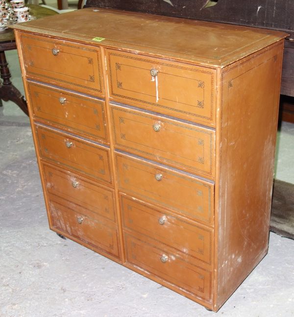 A 20th century brown leather and gilt tooled nine drawer chest. 80cm wide  E6