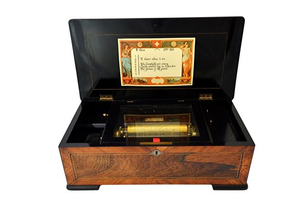 A Swiss music box, late 19th century, playing eight airs, with a six inch roller and applied ivory plaque detailed 'H D Scrine, 48 Dawes Road, Walham