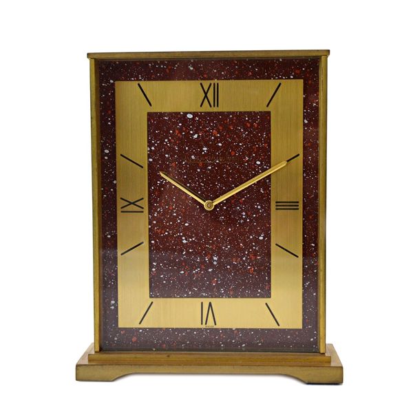 A Jaeger Le Coultre gilt metal eight day mantel clock, circa 1970, with red galaxy aventurine effect dial and Roman numerals on a gilt metal frame, st