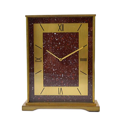 A Jaeger Le Coultre gilt metal eight day mantel clock, circa 1970, with red galaxy aventurine effect dial and Roman numerals on a gilt metal frame, st