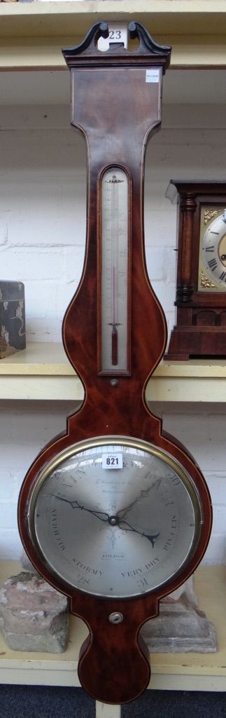 A Regency mahogany and line inlaid wheel barometer, 19th century, by Somalvico London, with broken arch pediment, applied thermometer and ten inch sil