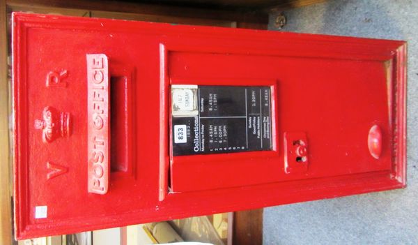 A Victorian cast iron wall mounted post box, the red painted front detailed with crown, V.R. cypher and inset collection card to the hinged door, 84cm