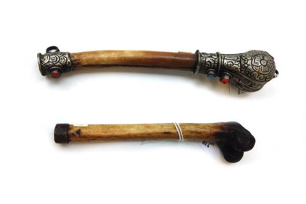 A thigh bone pipe, 19th century, with embossed white metal mounts and one further of plain naturalistic form 22cm (2).