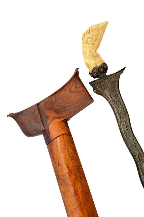 A 19th century Sumatran Kris, Jawa Demam style, the carved ivory handle in a pierced foliate mount embellished with polished gemstones, with a watered