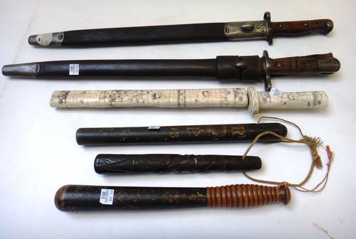 A Victorian truncheon with turned ribbed handle, 30.5cm long, an Irish bog oak truncheon carved with clover leaves, A George III wooden truncheon deta