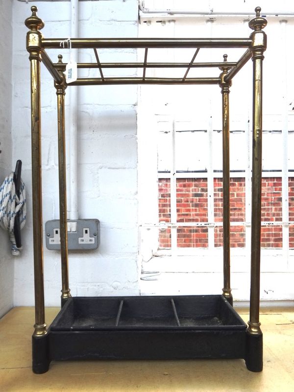 A Victorian tubular brass eight division stick stand, of rectangular form, with a cast iron base and removable drip pan, 62cm high.
