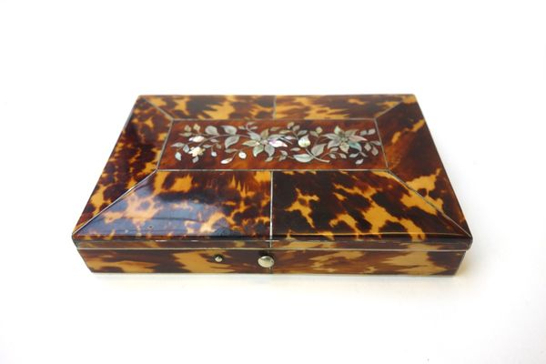 A Victorian tortoiseshell travelling etui case, the slightly domed hinged lid with foliate mother of pearl inlay, opening to reveal a blue velvet line