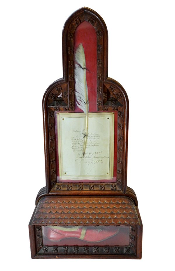 A mid-19th century carved oak and glazed reliquary, containing signed Papal indulgence of Pius IX, dated April 1858, a quill pen and a red leather pap