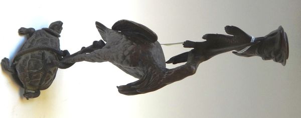 After Fratin, a bronze candlestick, mid-19th century, modelled and cast as a heron eating a fish atop a turtle, stamped 'Fratin' to the cast, 30cm hig