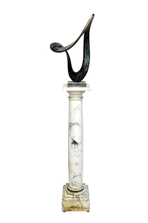 A green and gold patinated abstract bronze in the manner of Dennis Mitchell, unsigned, on a black slate plinth, 54cm high, raised on a white and grey