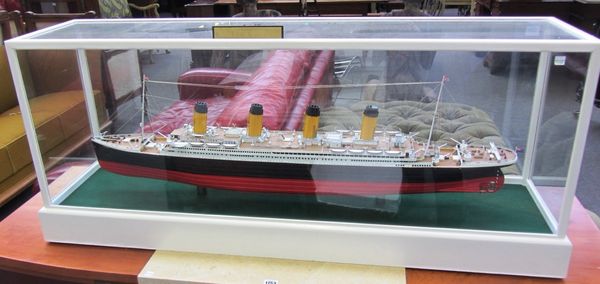 A scratch built model of RMS Titanic, late 20th century, contained in a white painted glazed wooden case, 126cm wide, and a 'History of Events' detail