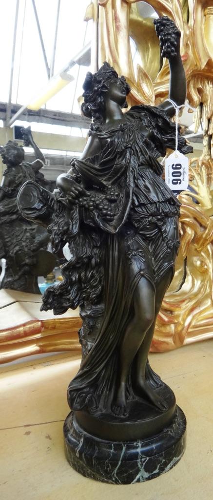 After Marin, a French bronze figure of a Bacchante, late 19th century, modelled and cast holding grapes and a tazza, with foundry stamp, on a circular