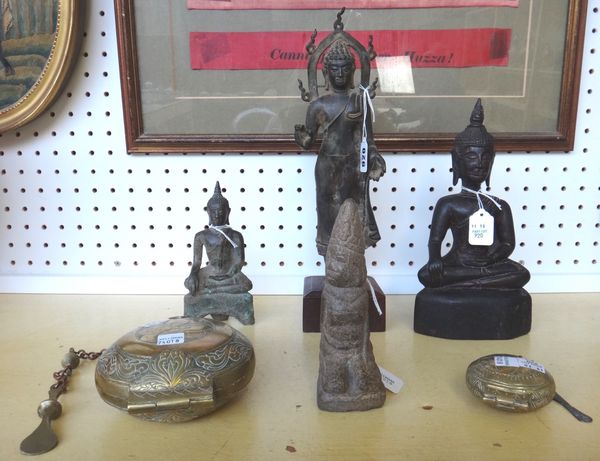 A South East Asian bronze figure, 20th century, mounted on a wooden base, 34cm high, together with a smaller metal Thai figure of Buddha, a similar wo