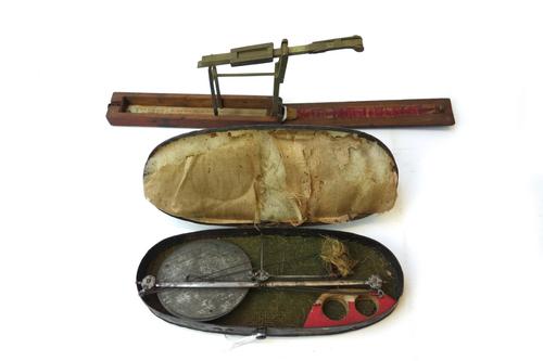 A Georgian mahogany cased brass Guinea and Half-Guinea scale, and a further pan scale, cased (2).