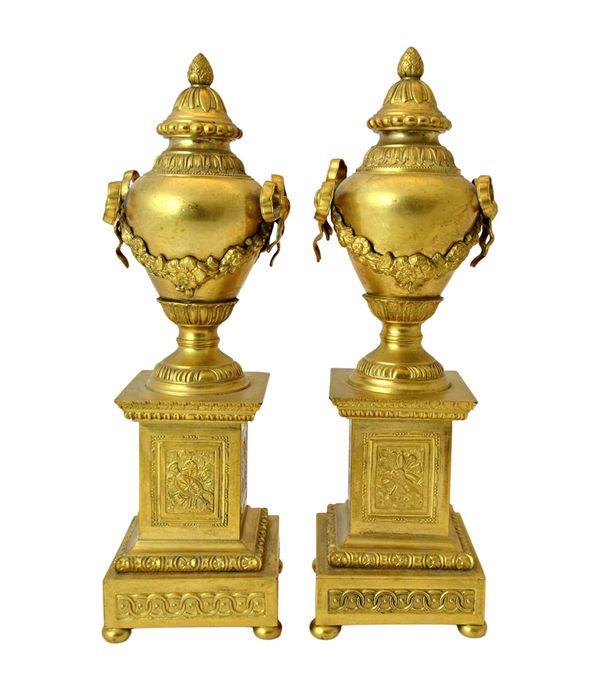 A pair of Georgian style gilt metal cassolettes, 20th century, each of urn form, on a stepped square plinth and bun feet, 27cm high (2). Illustrated.