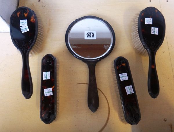 A five piece tortoiseshell and silver mounted dressing table set, hallmarked Birmingham 1945, comprising; a hand mirror, 26.5cm long, two hair brushes