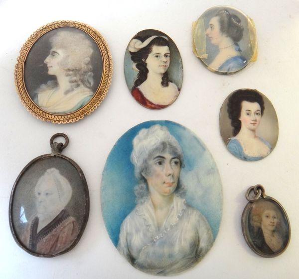 A late 18th English School portrait miniature on ivory of a woman in profile, wearing blue dress with pearl necklace, 3.7cms high; together with 6 oth