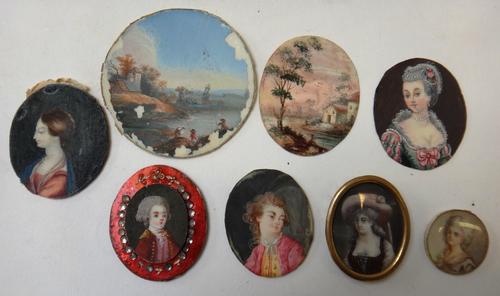 An early 19th century Continental portrait miniature on ivory of a young boy, 2.2cms high- set on a painted metal mount; 7 other small 19th Continenta