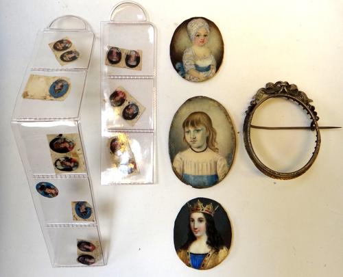 A mid-19th century portrait miniature of a young King, 4cm high; two portrait miniatures of children and fifteen late 19th century very small portrait