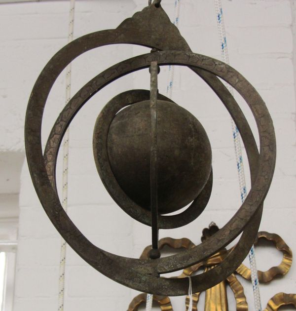 A Persian brass armillary sphere, 20th century, with suspension loop to outer ring, 36cm high.