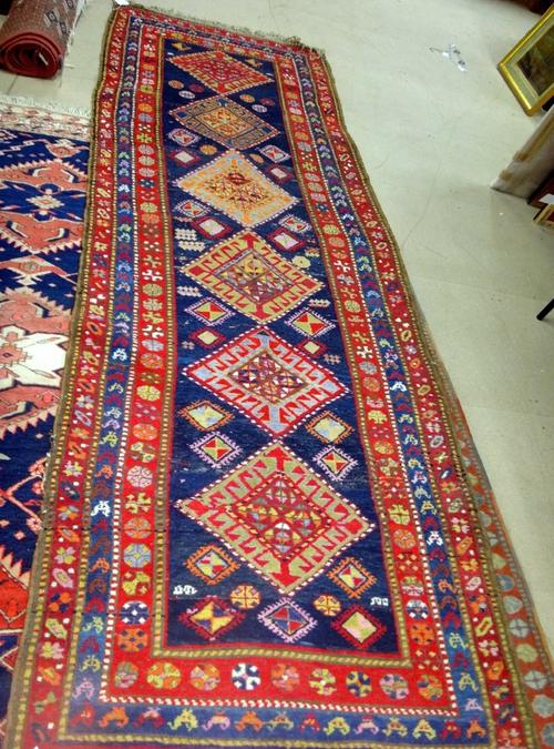 A Karajah runner, Caucasian, the indigo field with six bold hooked diamonds, minor motifs, three borders, 350cm x 114cm, and a Karajar Kelleh, the ind