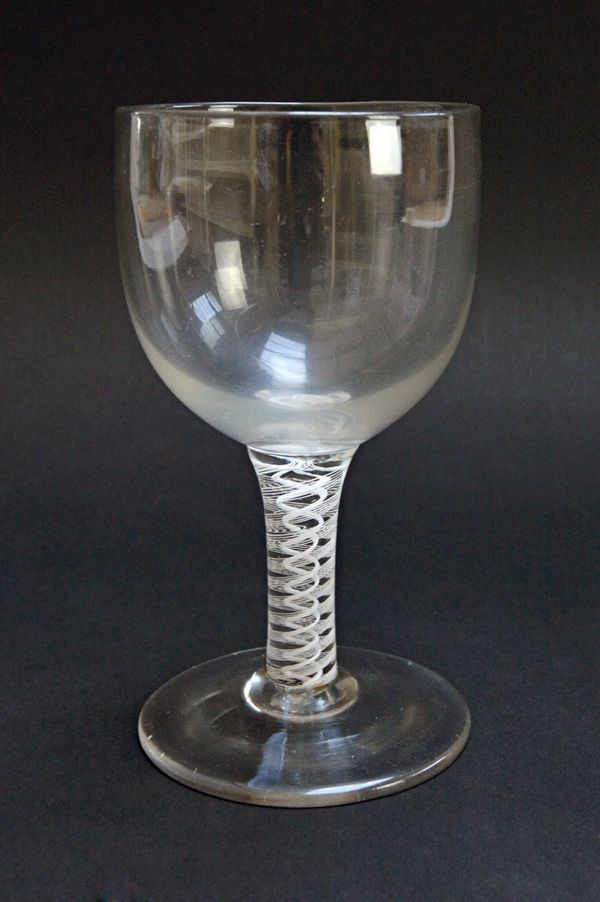 A wine goblet, circa 1765, with ovoid bowl and double series opaque twist stem, 16cm high. Illustrated
