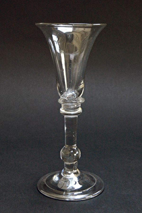 A balustroid wine glass, circa 1740, with trumpet bowl, baluster stem and folded foot, 15cm high. Illustrated