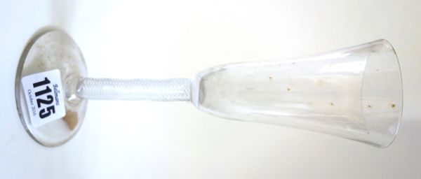A mid 18th century ale glass, with rounded funnel bowl and multi series airtwist stem, 20cm high.