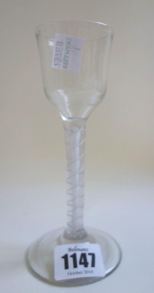 An 18th century wine glass, circa 1765, with ogee bowl and double series opaque twist stem, 15cm high.