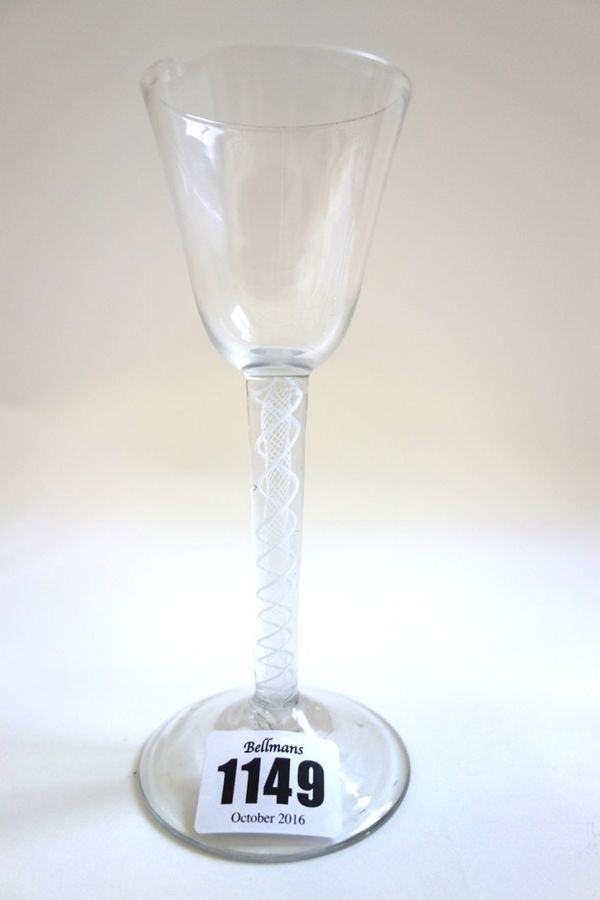 An 18th century wine glass, circa 1765, with rounded funnel bowl and double series opaque twist stem, 15.2cm high.