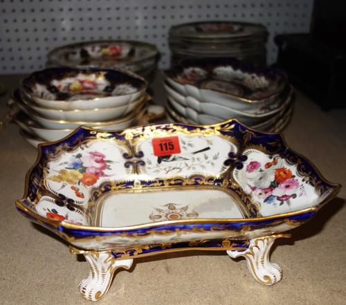 An early 19th century English blue and gilt part dinner and dessert service, painted with flowers and birds of paradise, (qty). S2M