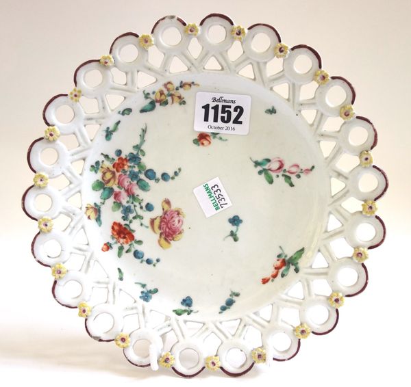 A Derby `spectacle' plate, circa 1765-70, painted with flower sprays and sprigs, the applied florets on the pierced border picked out in yellow and re
