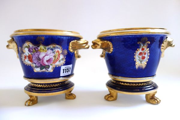 A pair of Coalport blue scale ground cache pot and stands, circa 1815, with kylin handles and foliate painted bodies on a circular stand with lions pa