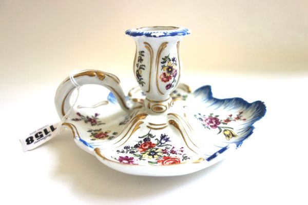 A Derby chamberstick, circa 1760, with shell and scroll moulding picked out in blue and gilding, painted with panels of flowers in the style of the `c