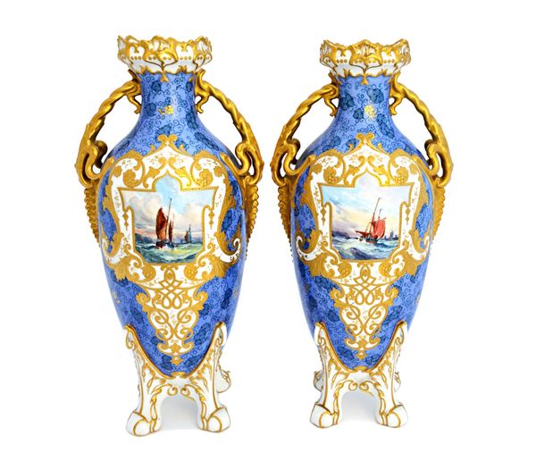 A pair of Royal Crown Derby two-handled vases, 1904, with iron red printed factory marks, painted with ships by W.E.J Dean, within elaborate tooled gi