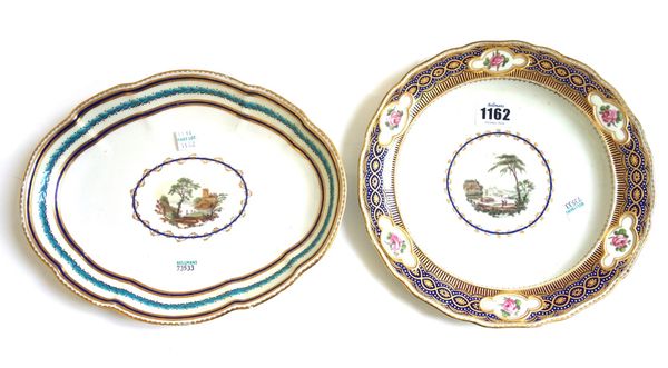A Derby plate, circa 1780-85, painted with pattern 35, a landscape vignette probably by Zachariah Boreman, inside a rich blue enamel and gilt border r