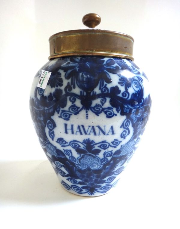 A Dutch Delft blue and white tobacco jar and brass cover, late 18th century, of small size, named for `Havana' inside a foliate cartouche and surmount