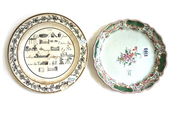 An Italian faience plate, probably Milan, circa 1770, painted in the centre with a flower spray inside a diaper panelled floral border, 19.5cm.diamete