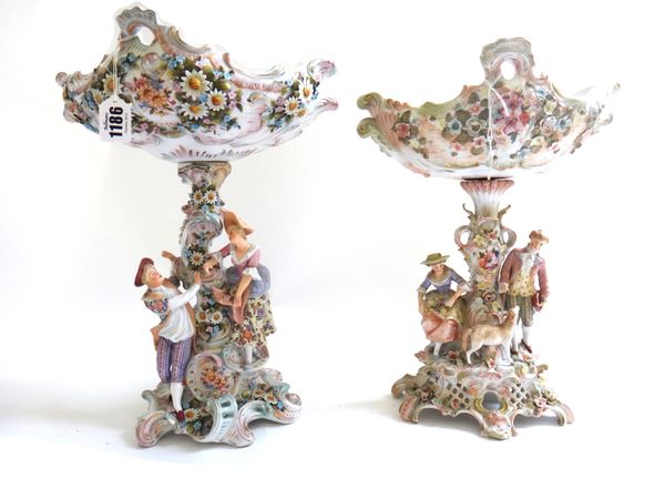 A Sitzendorf porcelain figural comport, 20th century, moulded with shepherd and shepherdess on a pierced scroll base, 36cm high, and another similar p