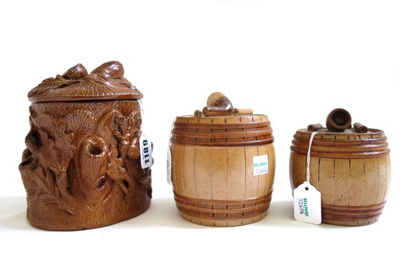 A pottery tobacco jar and cover, 19th century, moulded in high relief with naturalistic oak tree foliage (14.5cm high) and two further tobacco jars an