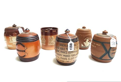A Doulton Lambeth stoneware tobacco jar and cover, 19th century, stamped JOHN MORTLOCK to the base and decorated with moral verse (13.5cm high), two D