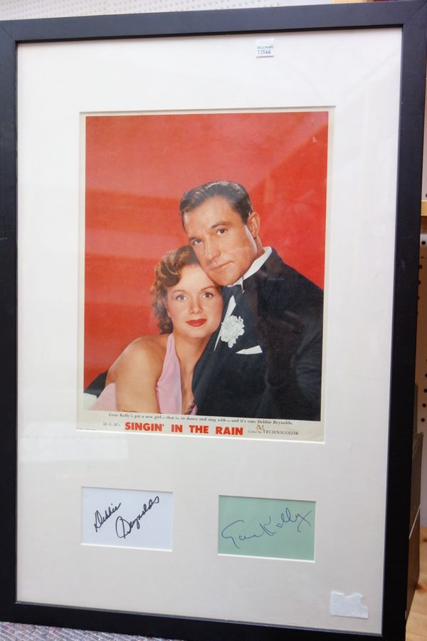 SINGIN' IN THE RAIN - mounted & framed coloured promotional Lobby Card photo. of Gene Kelly & Debbie Reynolds (head & shoulders), with inset autograph