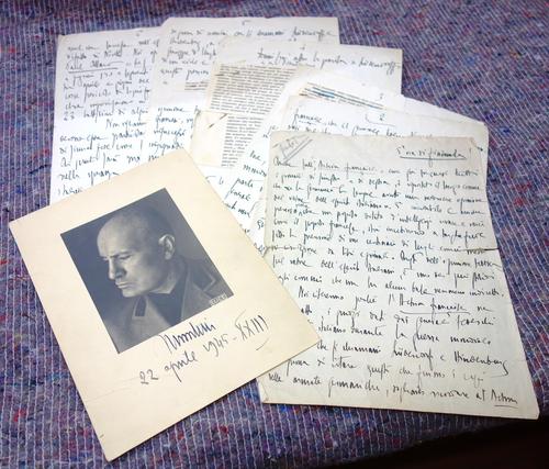 MUSSOLINI - b/w head & shoulders photo., printed on card & inscribed by subject beneath (April 1945); sold with 6 ms. leaves in Mussolini's hand (? an