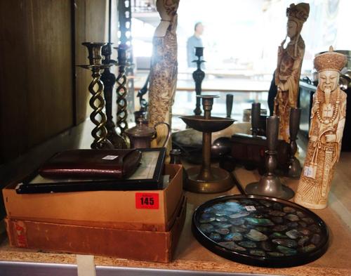A quantity of collectables, including a pair of brass candlesticks, resin figures, pewter wares, an 18th century cattle bell, a wall mounted snuff con