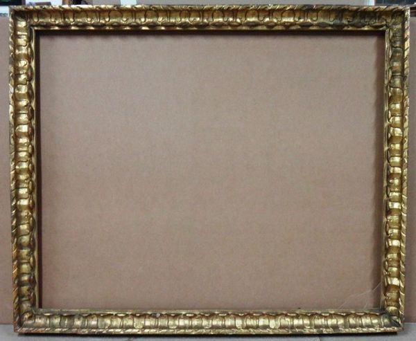 A carved giltwood frame with foliate and ropetwist decoration, the aperture 140cm wide x 103cm high.