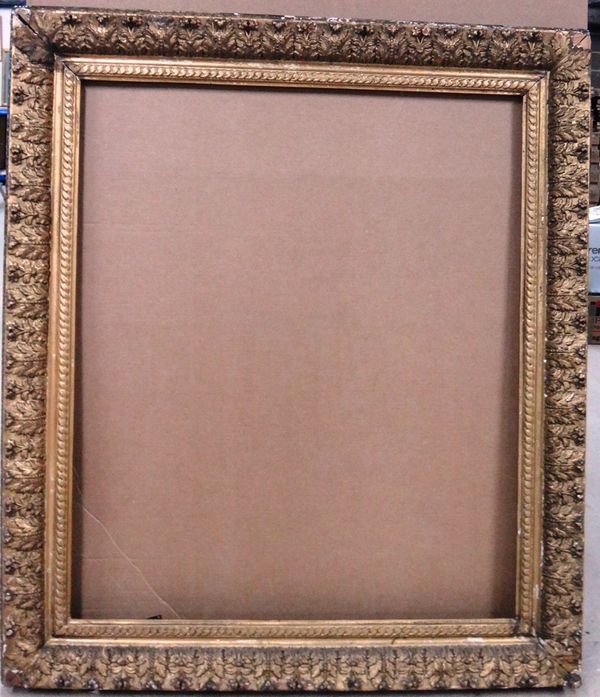 An early 19th century gilt plaster frame with foliate decoration, the aperture 99cm wide x 117cm high.