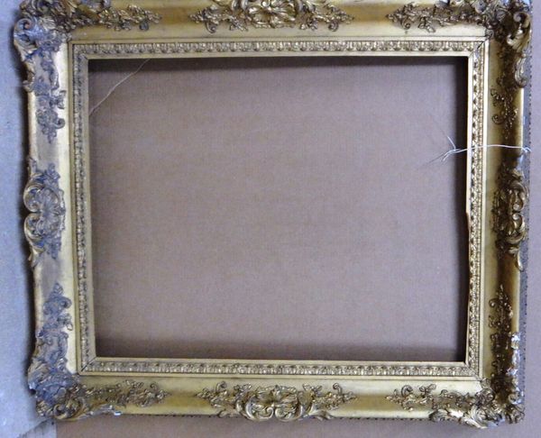 A 19th century gilt plaster swept frame with foliate decoration, the aperture 75cm wide x 92.5cm high.